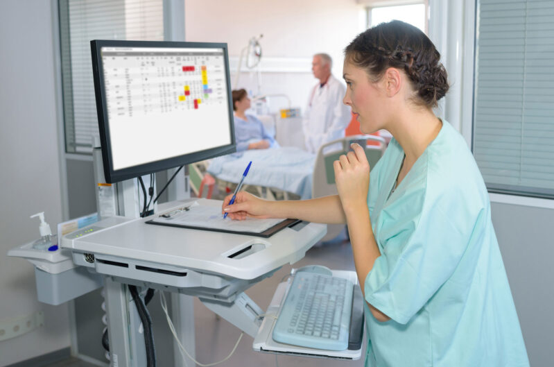 Bedside nurse with Vigilance on a computer screen