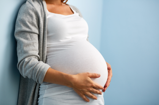 Pregnant woman on blue background