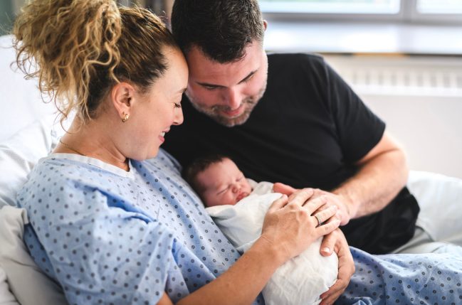 Mom and Dad hold their new baby
